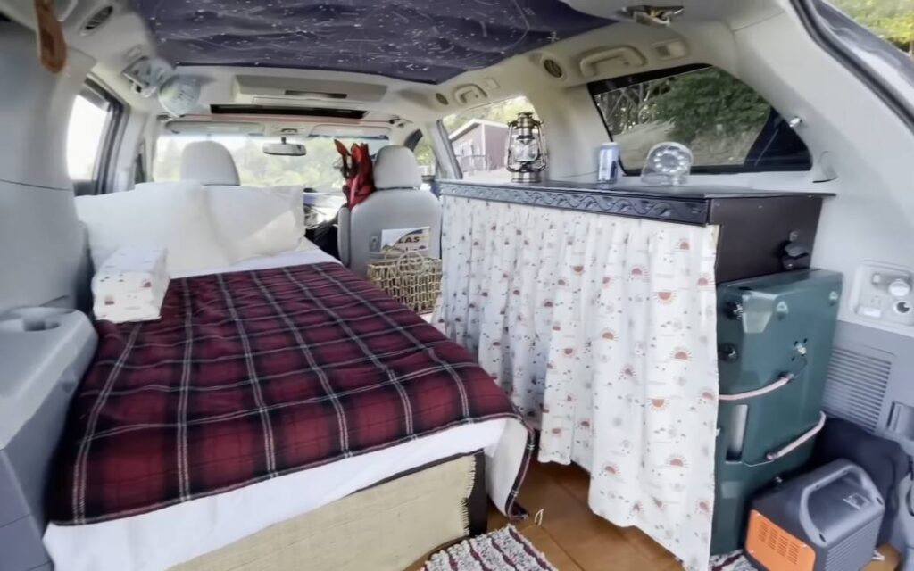 Cozy Interior of a Toyota Sienna Camper Conversion from @beer_in_beautiful_places