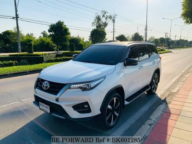 White front of toyota fortuner showcasing its sleek design and chrome accents, highlighting its urban appeal