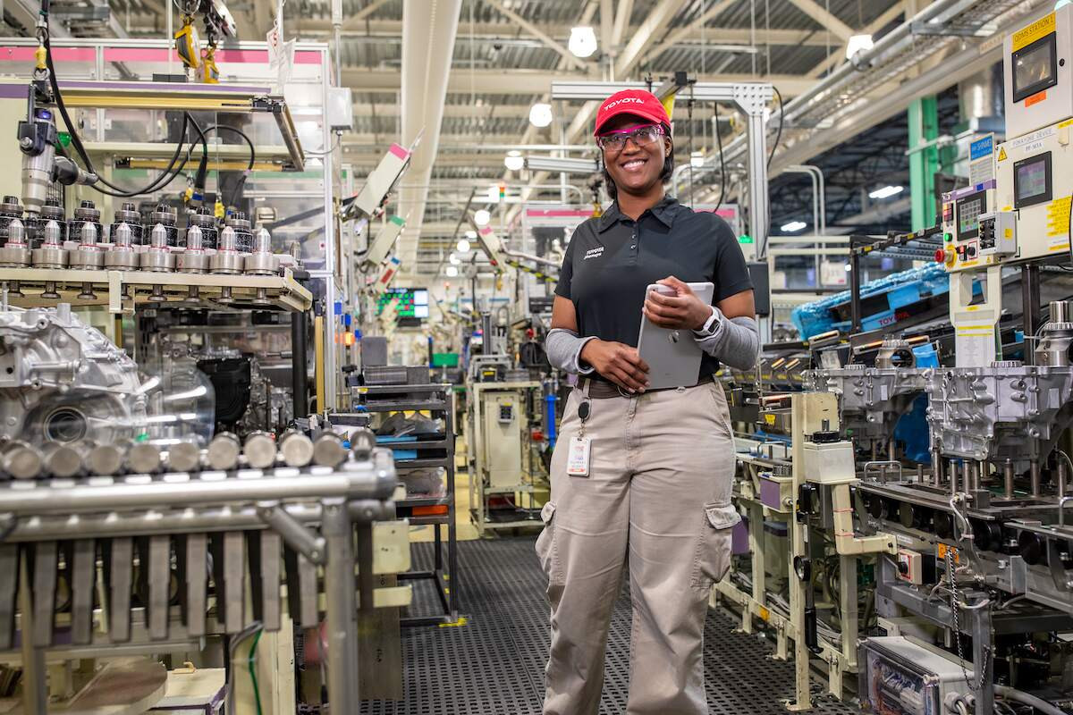 Robots assemble panels around the vehicle's frame at Toyota factory