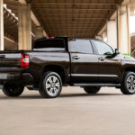 Toyota Tundra 1794 edition interior with 1794 edition floor mats and center console, along with wood trim on the steering wheel, dash, and gear shift