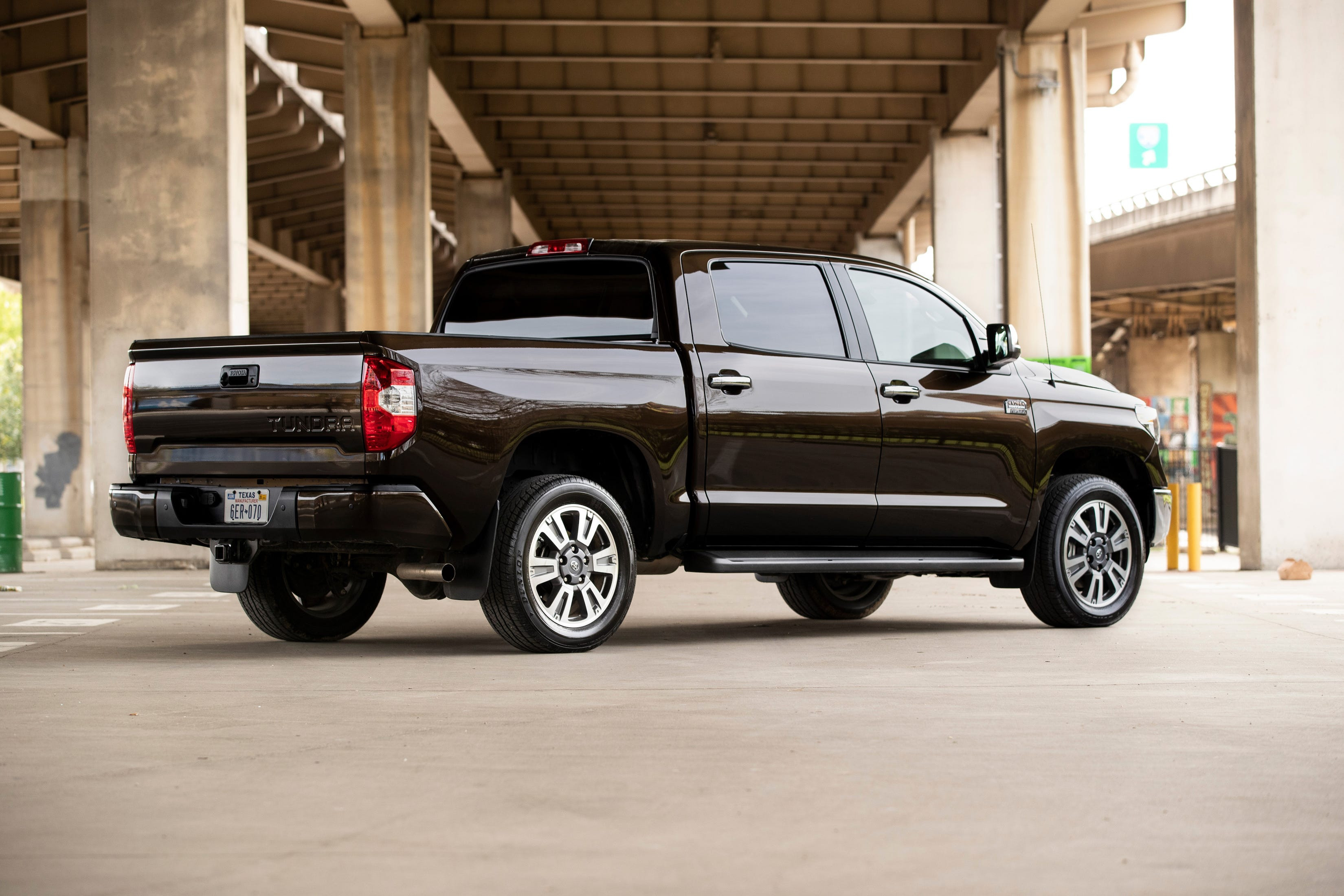 Toyota Tundra 1794 edition interior with 1794 edition floor mats and center console, along with wood trim on the steering wheel, dash, and gear shift