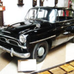 1955 Toyota Crown parked on display, capturing the car's classic design.